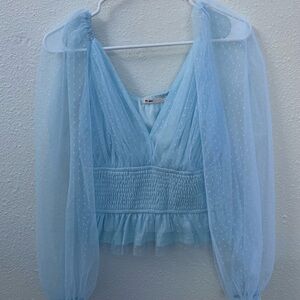 Francesca’s blue puffy sleeved shirt